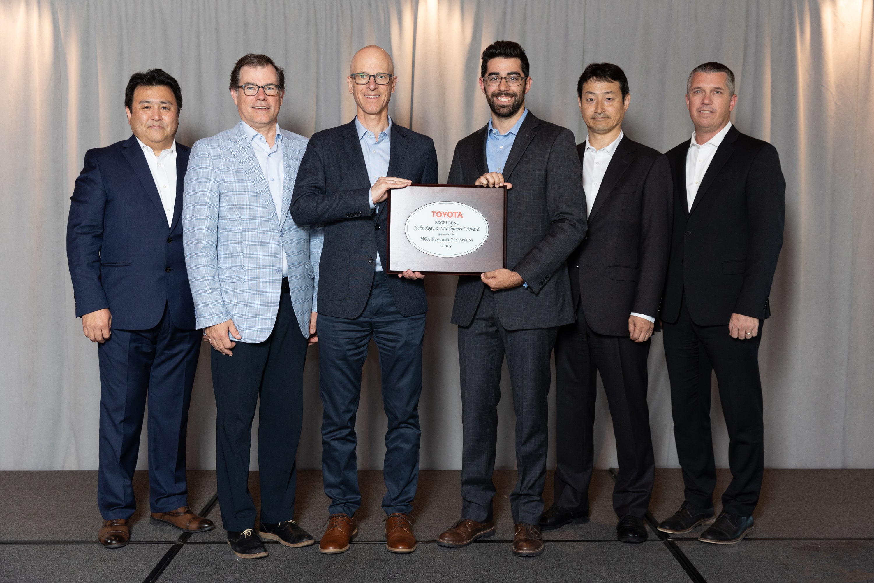 The MGA team receiving the technology and development award from the Toyota North America team at the annual supplier business meeting dinner and award ceremony.